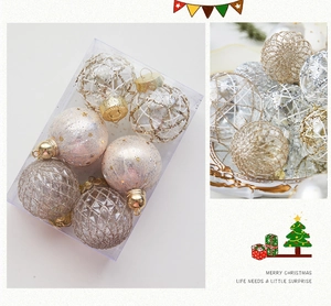 Detailed view of champagne gold and silver Christmas ornament balls in a clear gift box