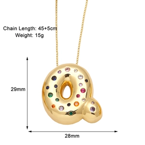 Macro detail of letter Q pendant with multicolored zircons and dimensions of 29mm by 28mm