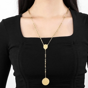 Close-up of gold stainless steel 6mm bead Y-necklace with religious embossed pendants