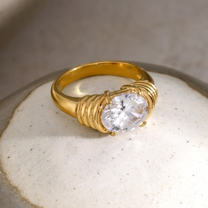 Detail of 18k gold plated stainless steel ring with oval crystal and ribbed band