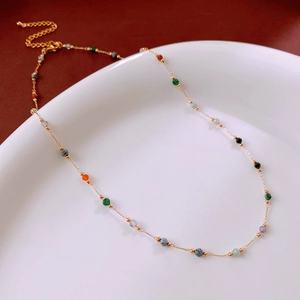 Detail of gold chain necklace with colorful beads and adjustable lobster clasp closure