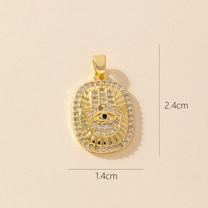 Close-up of gold Hamsa Hand pendant with zircon stones and 2.4cm x 1.4cm dimensions