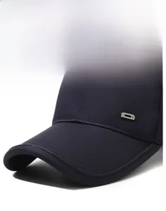 Detailed close-up of navy blue cotton twill baseball cap with silver metal D-letter logo