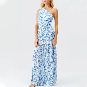Detail of one-shoulder floral dress with blue tropical leaf patterns and pleated hemline