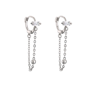 Macro detail of silver tassel earrings featuring rectangular zircon and polished bead charms