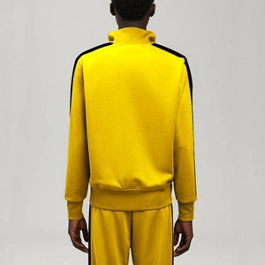 Rear view of yellow sport set featuring side stripes and stand collar track jacket