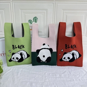 Detailed texture of knit tote bags featuring cute panda patterns and BLACK lettering