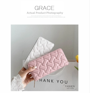 Detail of pink and white long PU leather wallets with embossed woven texture and zippers