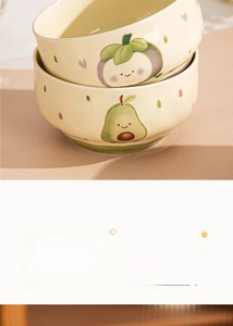 Detail of hand-painted ceramic bowls with cute fruit patterns, microwave and oven safe