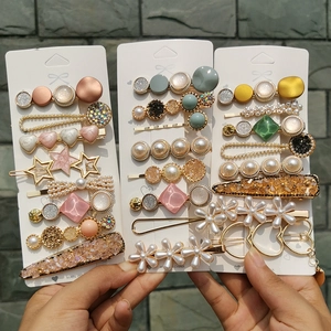 Detail of candy color hair clip set featuring pearls, stars, and heart shapes
