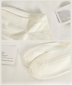 Detail view of reinforced heel and seamless toe on white ribbed combed cotton socks