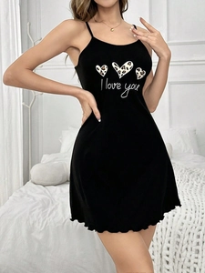 Detail of black camisole dress featuring leopard heart prints and ruffled hem design