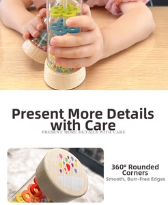 Detail of wooden rainmaker rattle with transparent tube and smooth 360-degree rounded edges