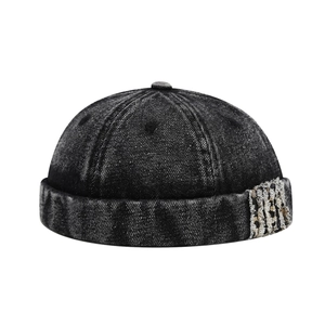 Black washed denim docker cap with leopard patch detail and vintage brimless texture