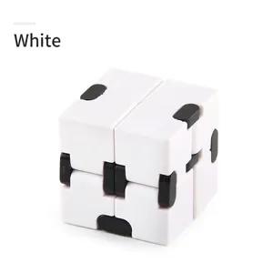 Macro shot of white infinity cube toy with black joints for stress relief and focusing