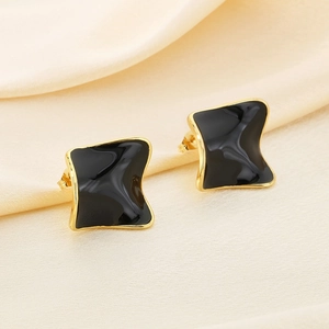 Elegant gold-edged square earrings with black enamel inlay on soft silk fabric
