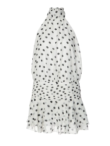 Close-up of white halter neck dress with black polka dots and tiered ruffle hem detail
