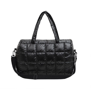 Black quilted puffer handbag with top handles and adjustable shoulder strap in nylon style