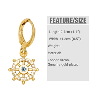 Detail view of gold-plated helm earring with evil eye and zircon stones for size reference