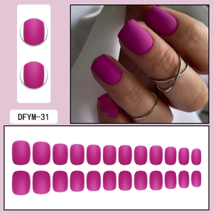 Macro detail of 24pcs matte magenta press-on nails in short square round shape