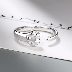 Adjustable silver cat paw ring with detailed paw pad carving in a polished finish