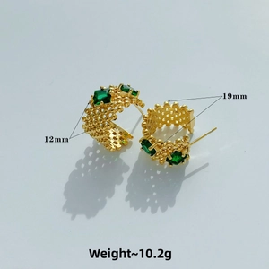 Detail showing 19mm gold C-shape earrings with emerald green zircons and woven texture