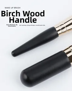 Detail of birch wood brush handles with matte black finish and gold metal ferrule