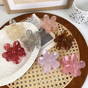 Detailed close-up of translucent jelly-colored floral hair claws in seven assorted shades