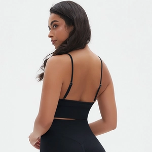 Detail view of seamless black yoga sports bra with thin straps and open back design