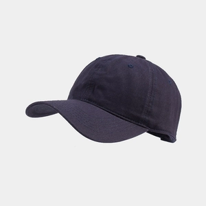 Detail of navy blue cotton baseball cap showing six-panel stitch and curved brim texture