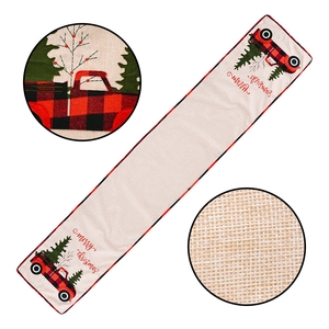 Festive Christmas table runner with red truck and green tree embroidery on linen fabric