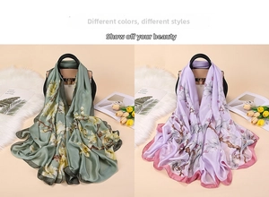 Detail of printed silk scarves in sage green and lilac with floral magnolia patterns