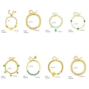 Collection of gold plated bracelets with butterfly and turquoise charms on white background