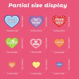 Detailed size chart for nine colorful heart-shaped Valentine stickers in cm and inches