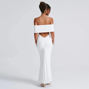Detail of white strapless maxi dress featuring an open back and ruched texture