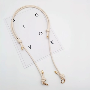 Adjustable beige leather strap with gold hardware for shoulder or crossbody bags