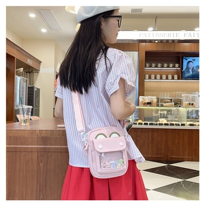 Pink Japanese ita bag with transparent window and cute frog flap shown on a model