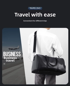 Detail of black leather travel bag showing texture, dual handles and shoulder strap hooks