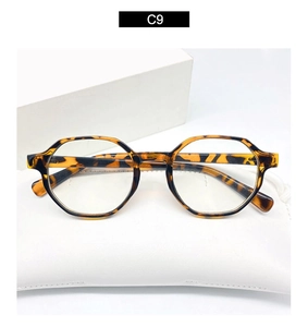 Detailed close-up of tortoise shell anti-blue light glasses on a white leather pouch