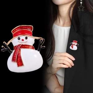 Enameled snowman brooch with red hat on black suit lapel, festive Christmas accessory