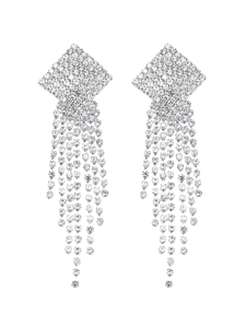 Macro shot of sparkling long tassel earrings with geometric squares and rhinestones