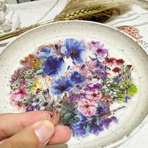 Detail showing translucent floral PET sticker with vibrant blue and pink ink patterns