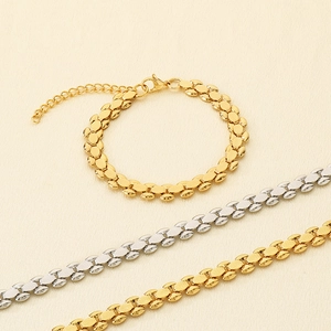 Detail of gold and silver watch-band style bracelets with lobster clasp and chain links