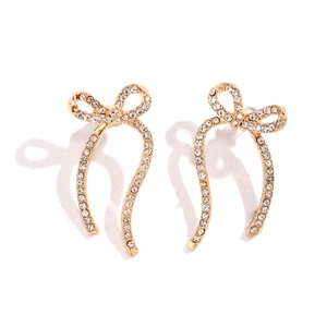 Detail of gold bow earrings with ribbon design and sparkling crystal rhinestones