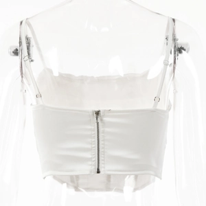 Close-up of a white satin crop top featuring a functional metal zipper closure on the back