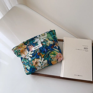 Floral cotton pouch with zip closure and simple wish label beside a book on a tray