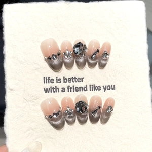 Handmade cat eye press-on nails with dark obsidian rhinestones and silver floral accents