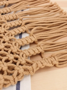 Handmade woven mesh shoulder bag with fringe tassel detail in natural beige finish