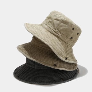 Detail view of cotton bucket hats with reinforced stitching and metal air vents