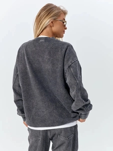 Back view of a vintage washed black crewneck sweatshirt in 100% premium cotton fabric